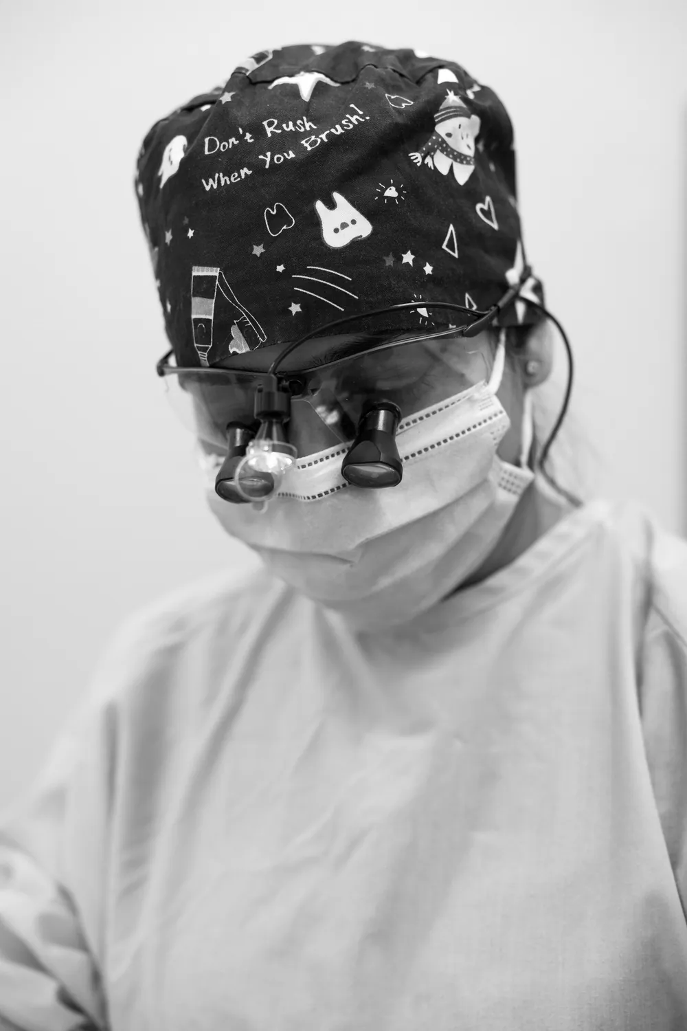 Dental team member wearing loupes while treating a patient